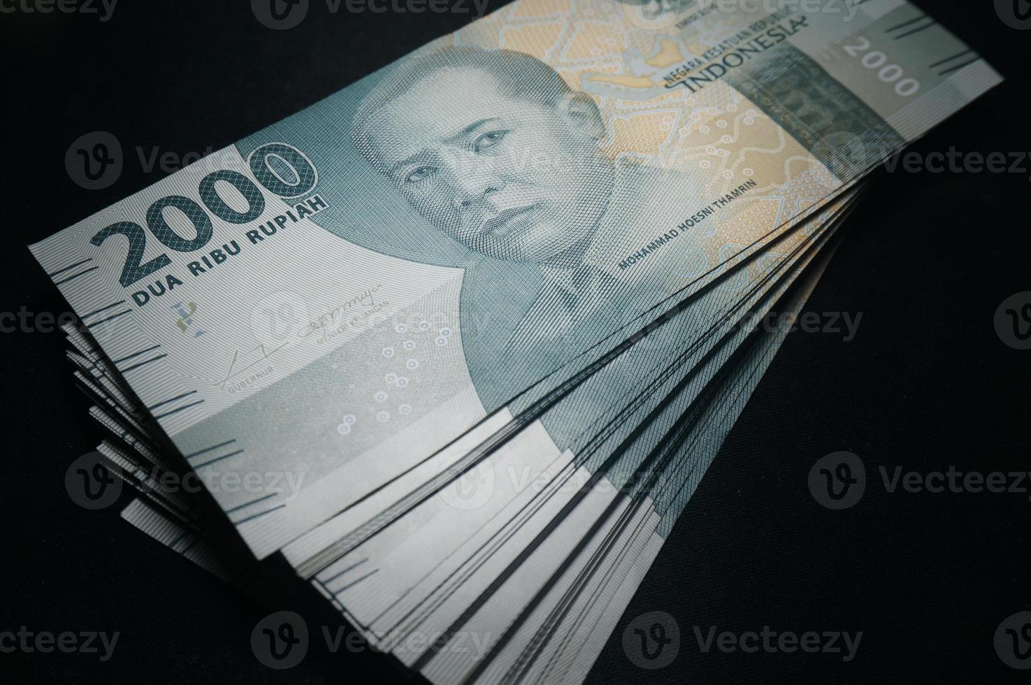 Money indonesian Rupiah Banknotes, Two thousand thousand rupiah, Isolated on black background, Indonesian Currency . photo