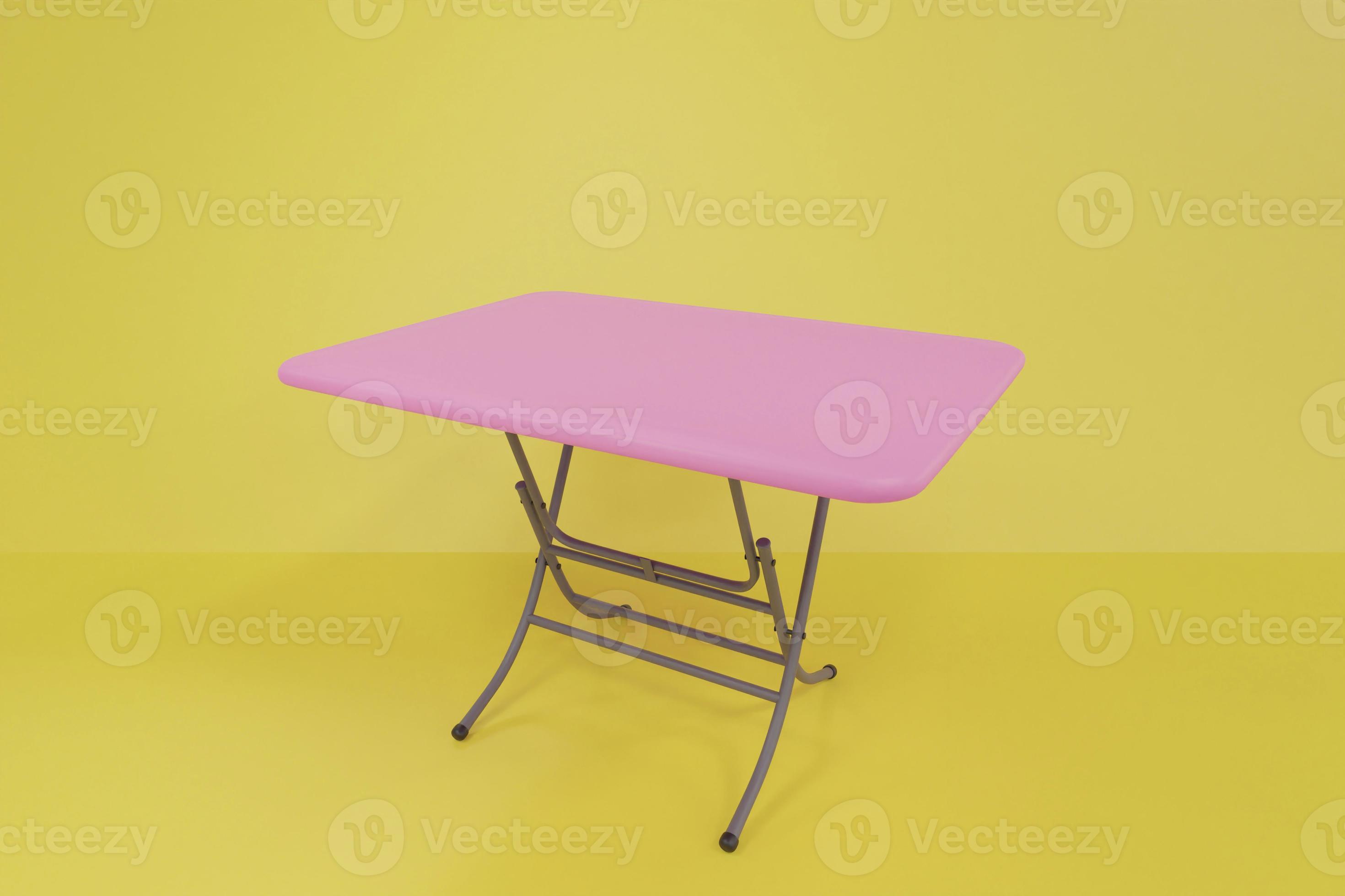 Pink folding table the legs of the table are steel frames in the yellow