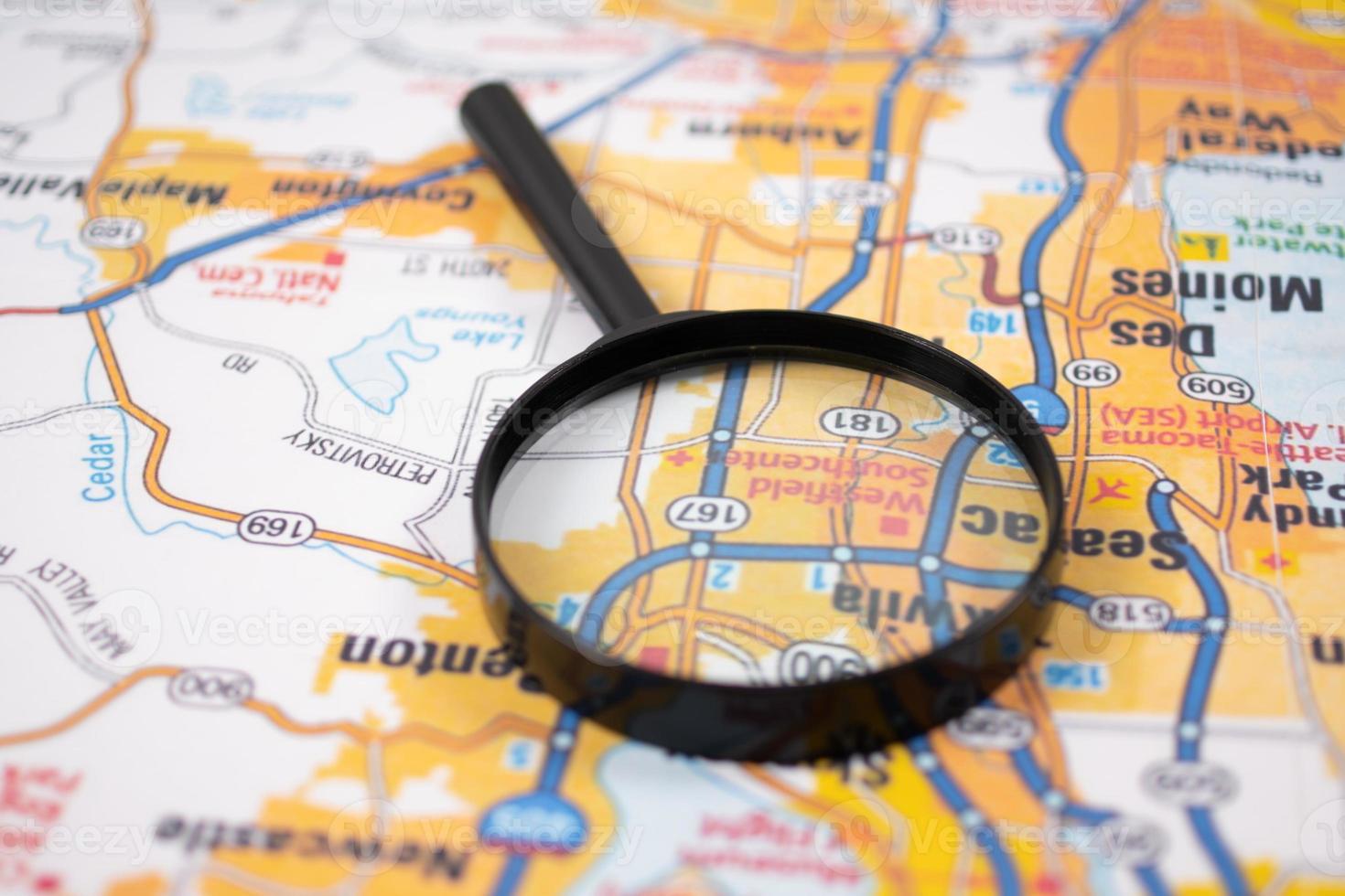 Concept of travel. Map and magnifying glass. photo