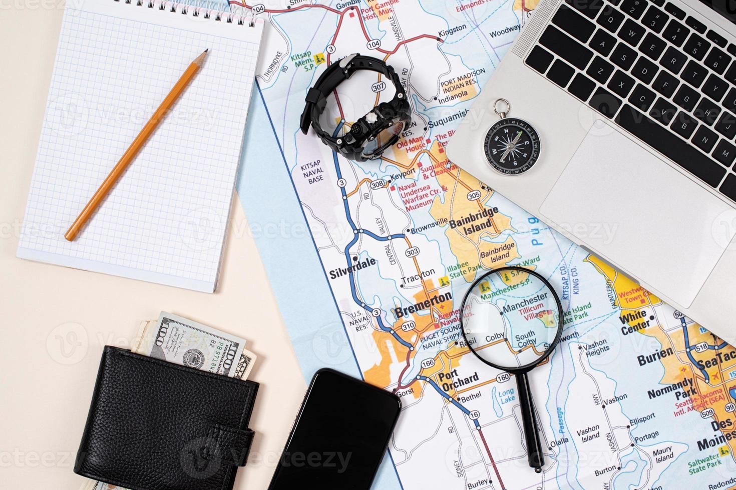 traveler accessories with map, devices and clothes on white background photo