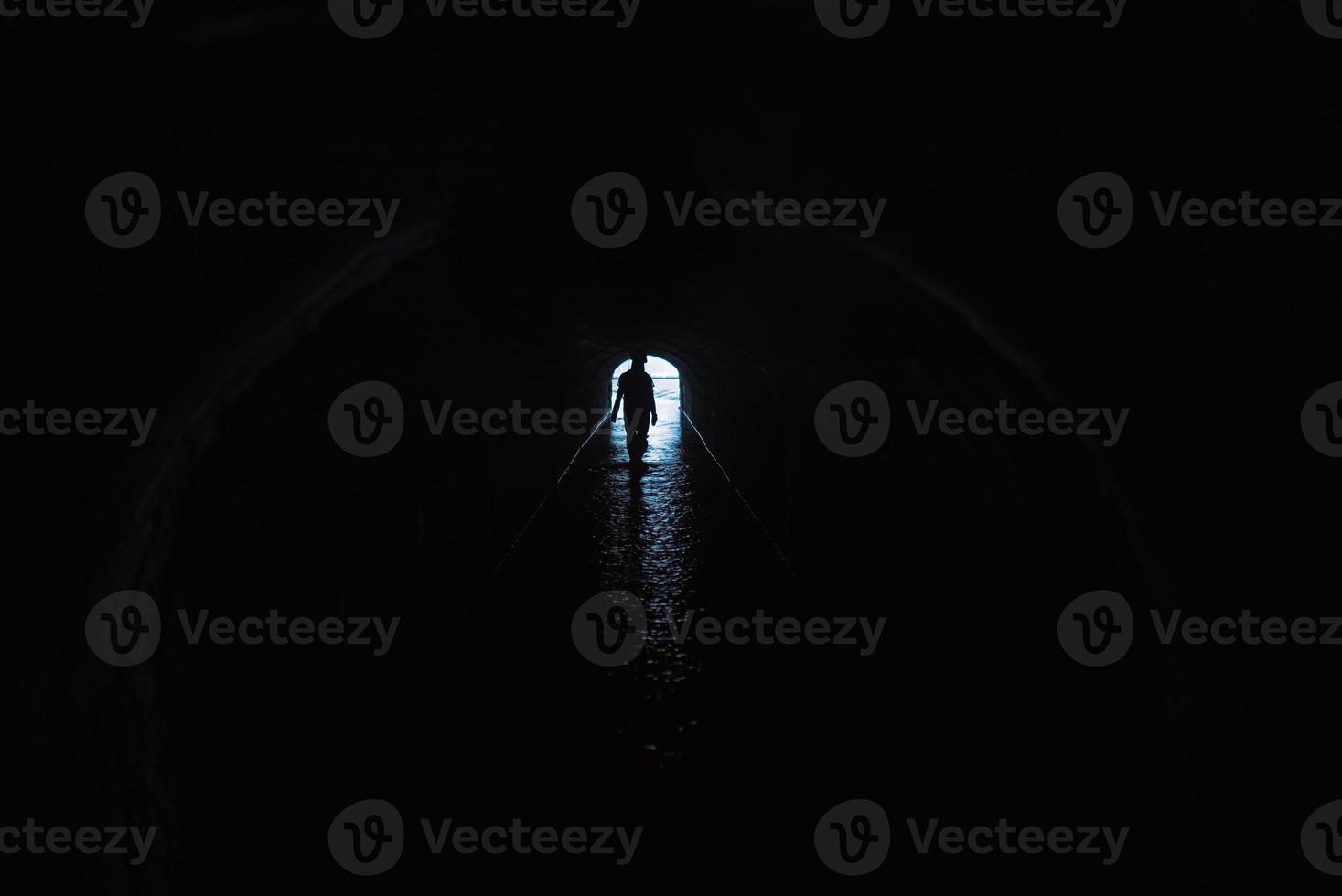 Silhouette of a woman in a tunnel photo
