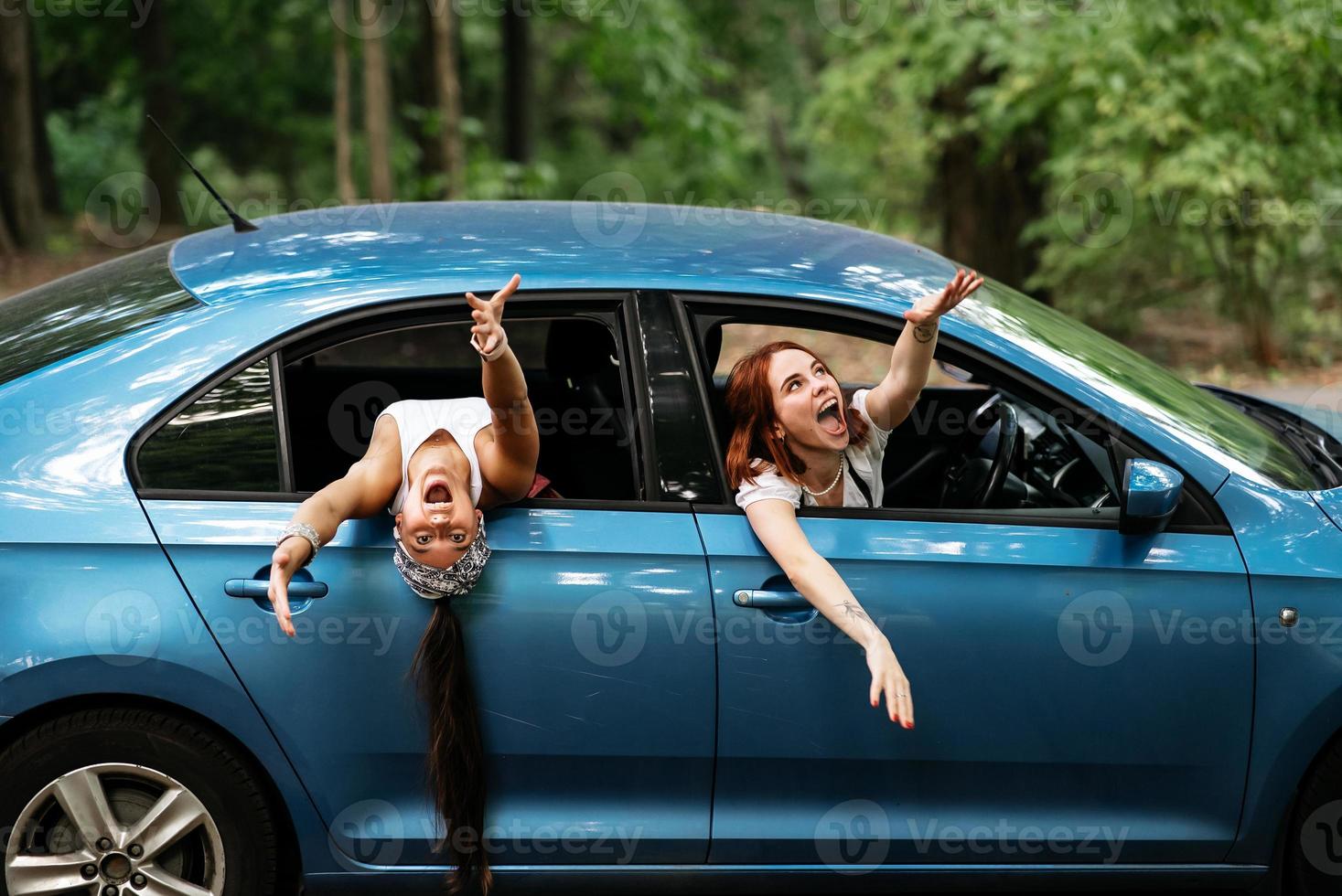 dos amigas se divierten y se ríen juntas en un auto foto