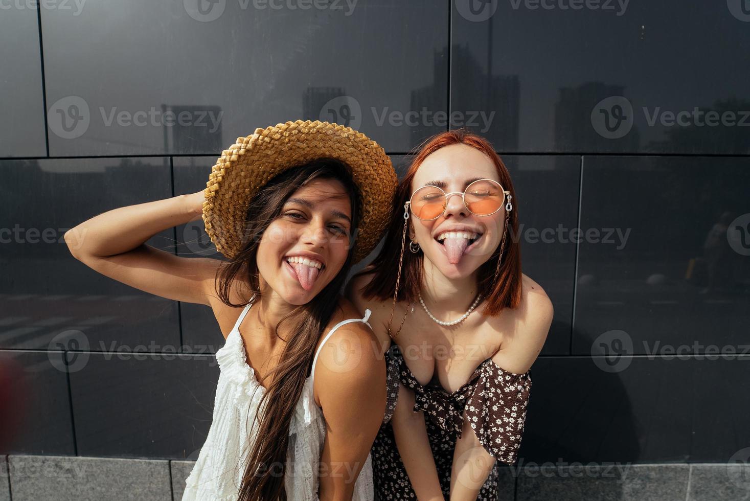 Two attractive young women fooling around in fresh air. photo
