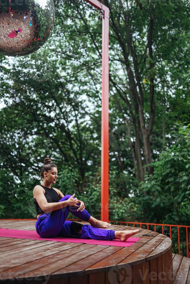 A young woman in doing yoga in the yard photo