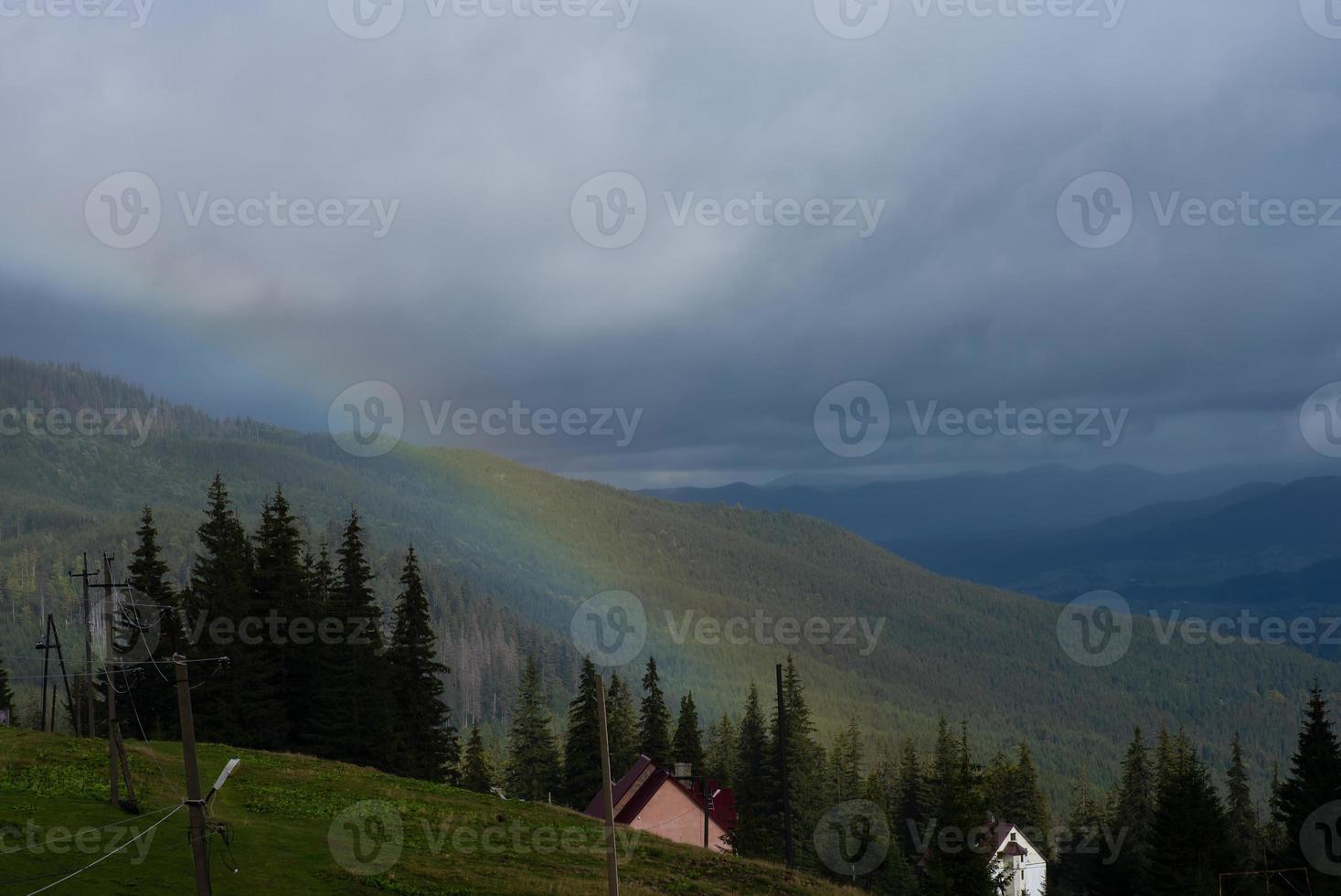 Rainbow over mountain peak photo