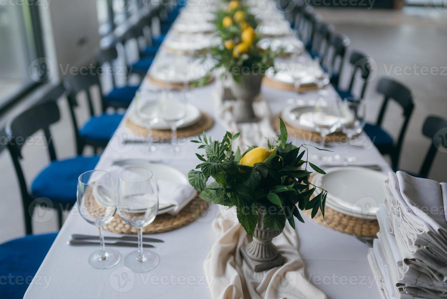 Festive table at the wedding party decorated with lemon arrangements photo