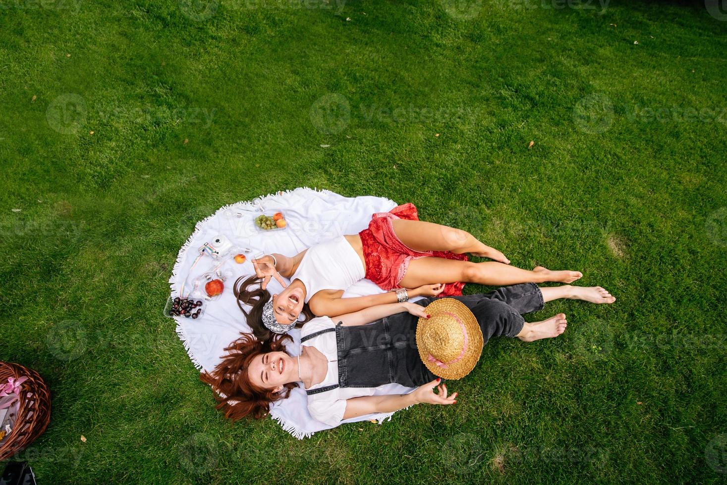 Top view, two young women lying in the park photo