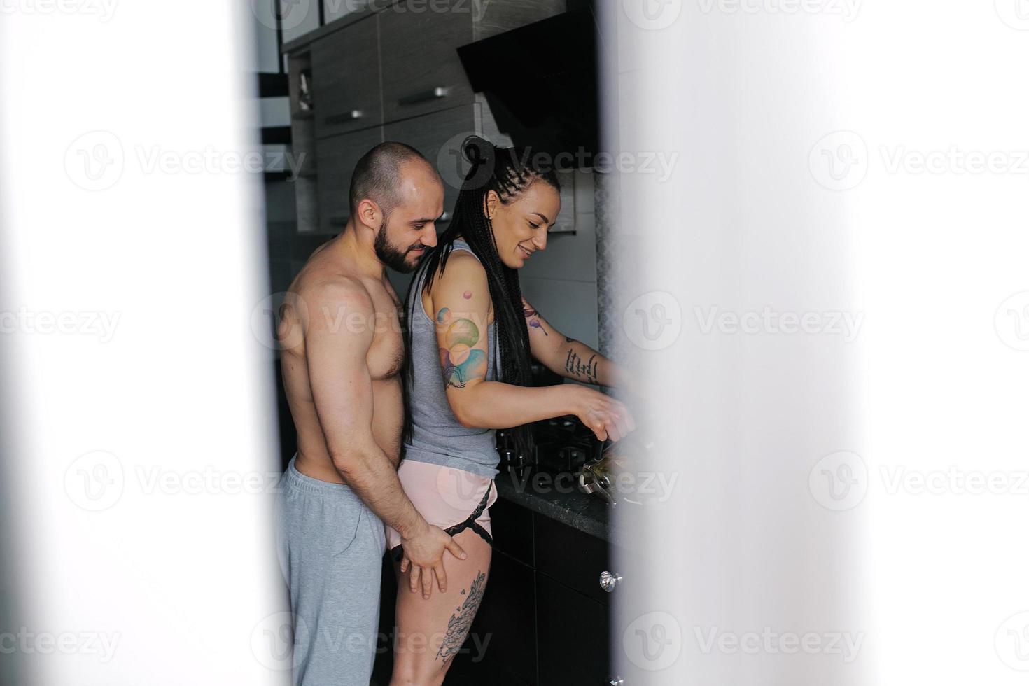 man and woman in the kitchen photo