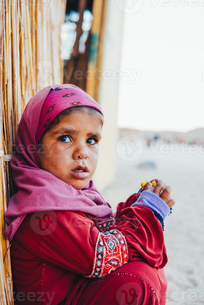 poor, sad little child girl sitting photo