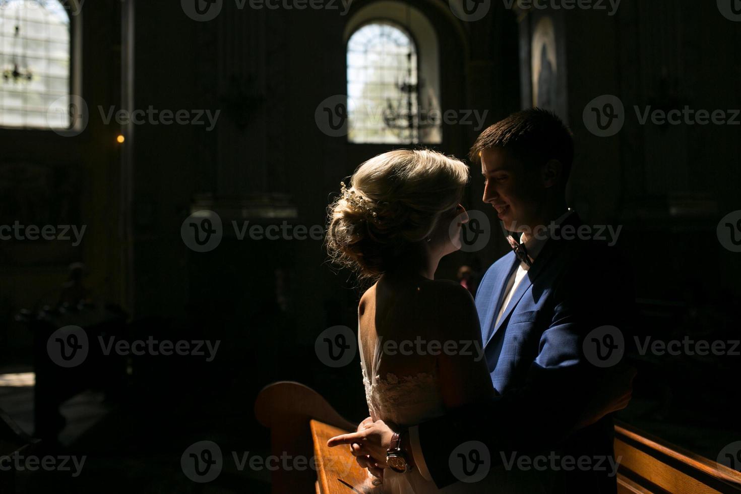 bride and groom illuminated by light photo