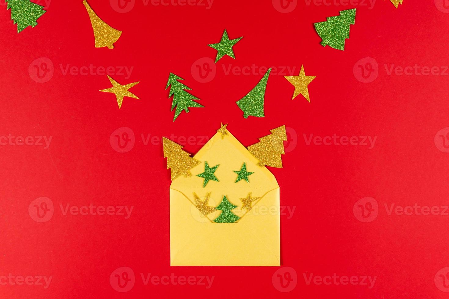 New Year red background with golden envelope and paper star and tree, flat lay photo