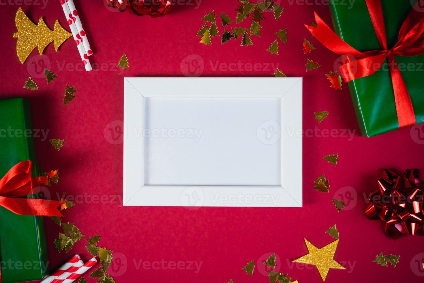 New Year and Christmas decorations on red background, flat lay. Concept of greeting card for holidays photo