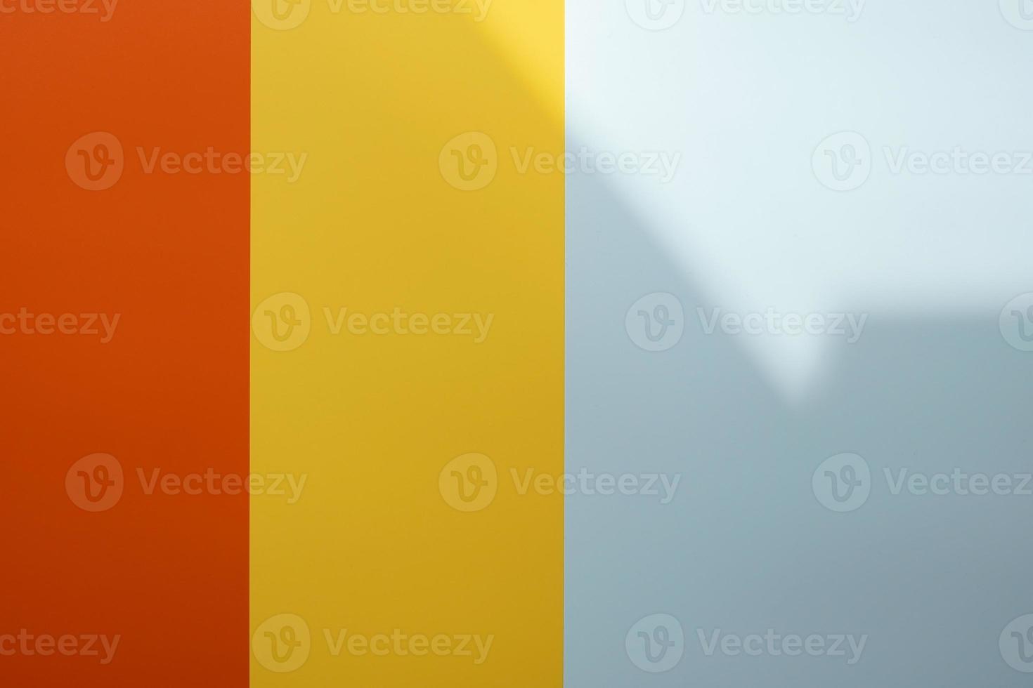 Background of red, yellow and gray colors with a shadow. Colored vertical stripes of different widths. Copy space. photo