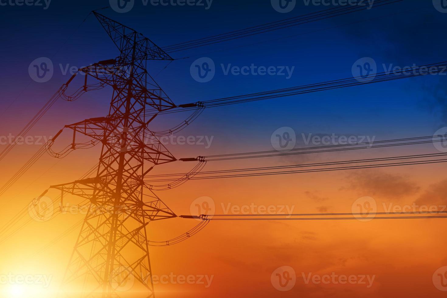 High voltage towers against the sunset background photo