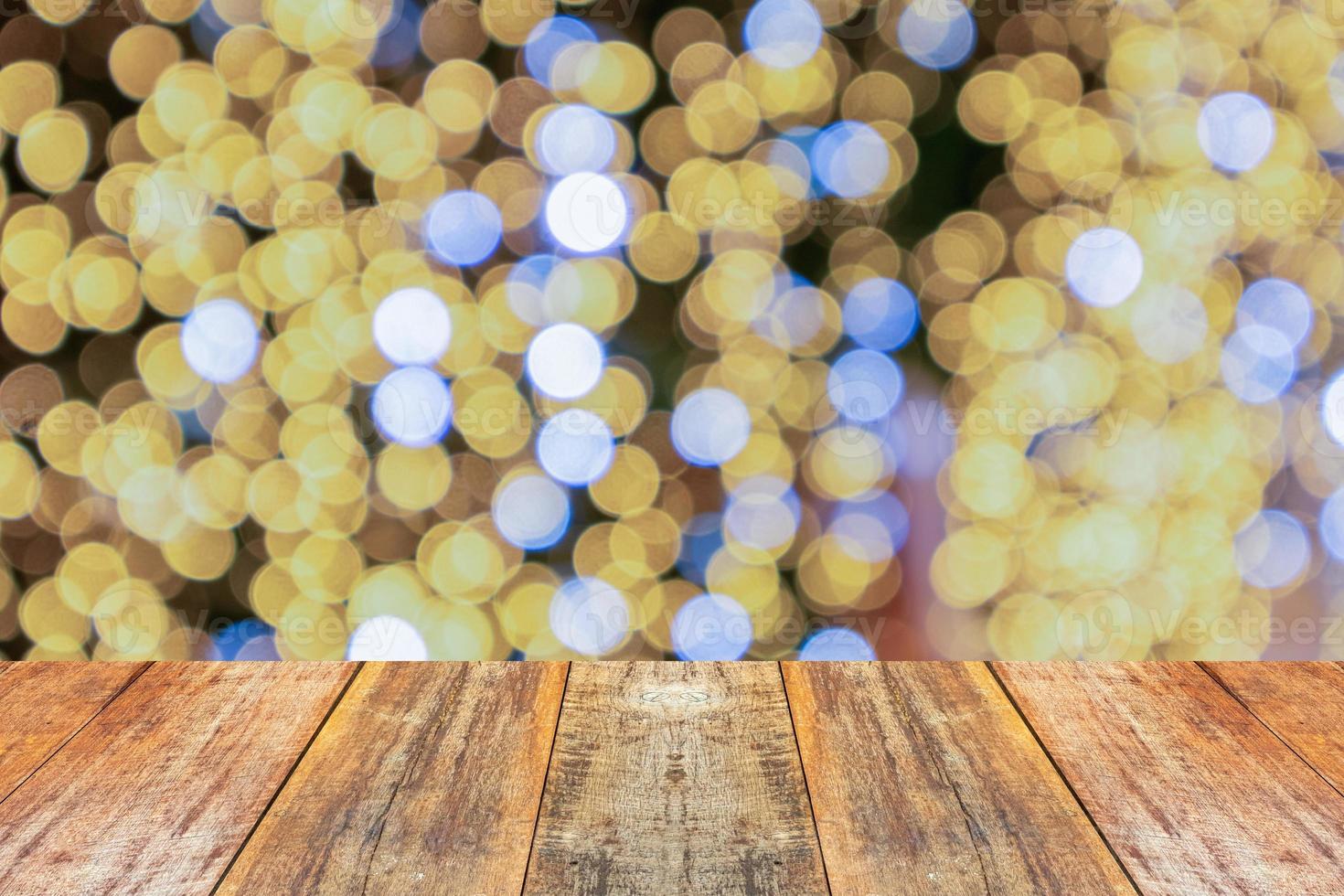 Empty wood table top with blur Christmas tree with bokeh light background photo