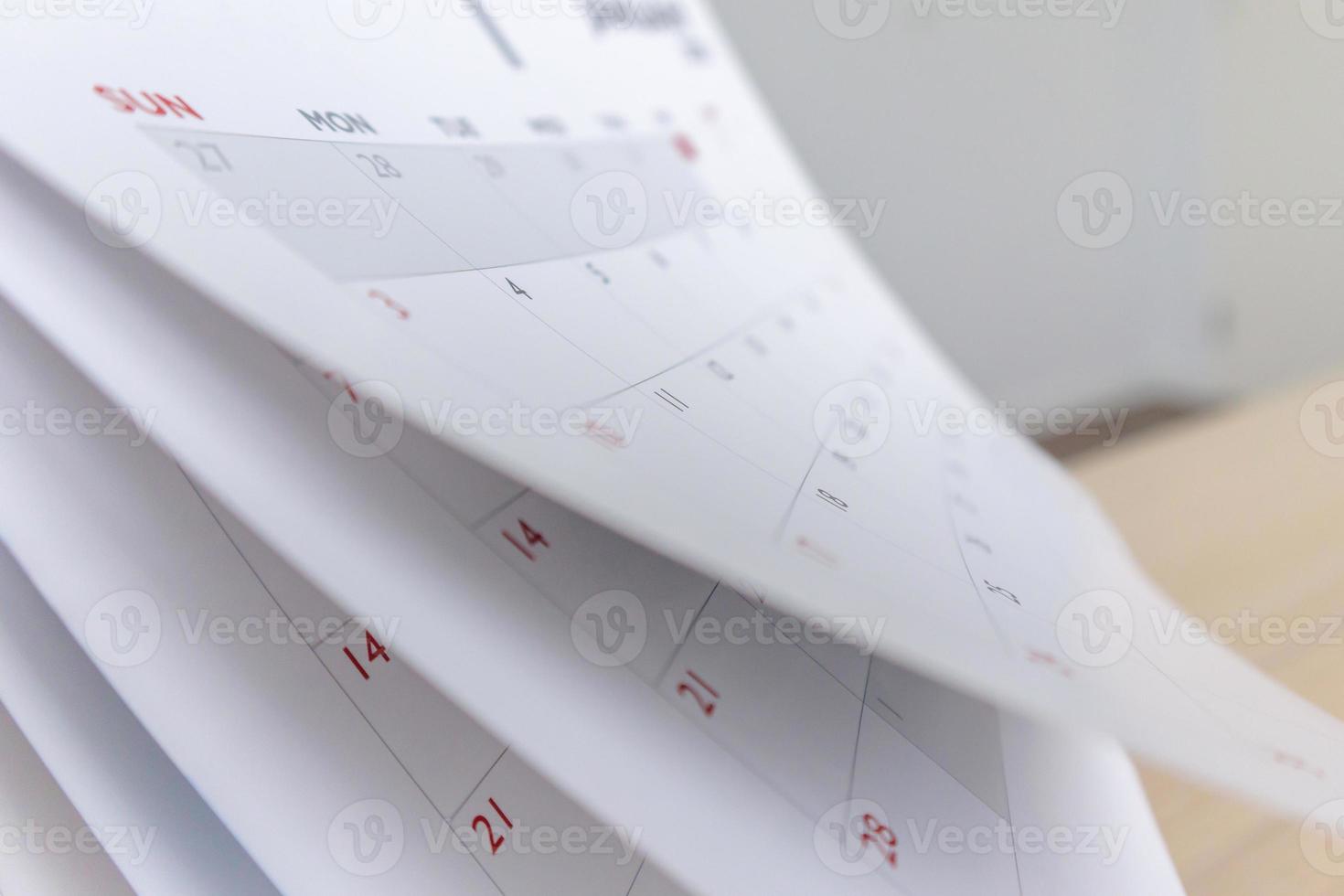 Calendar page flipping sheet close up blur background business schedule planning appointment meeting concept photo