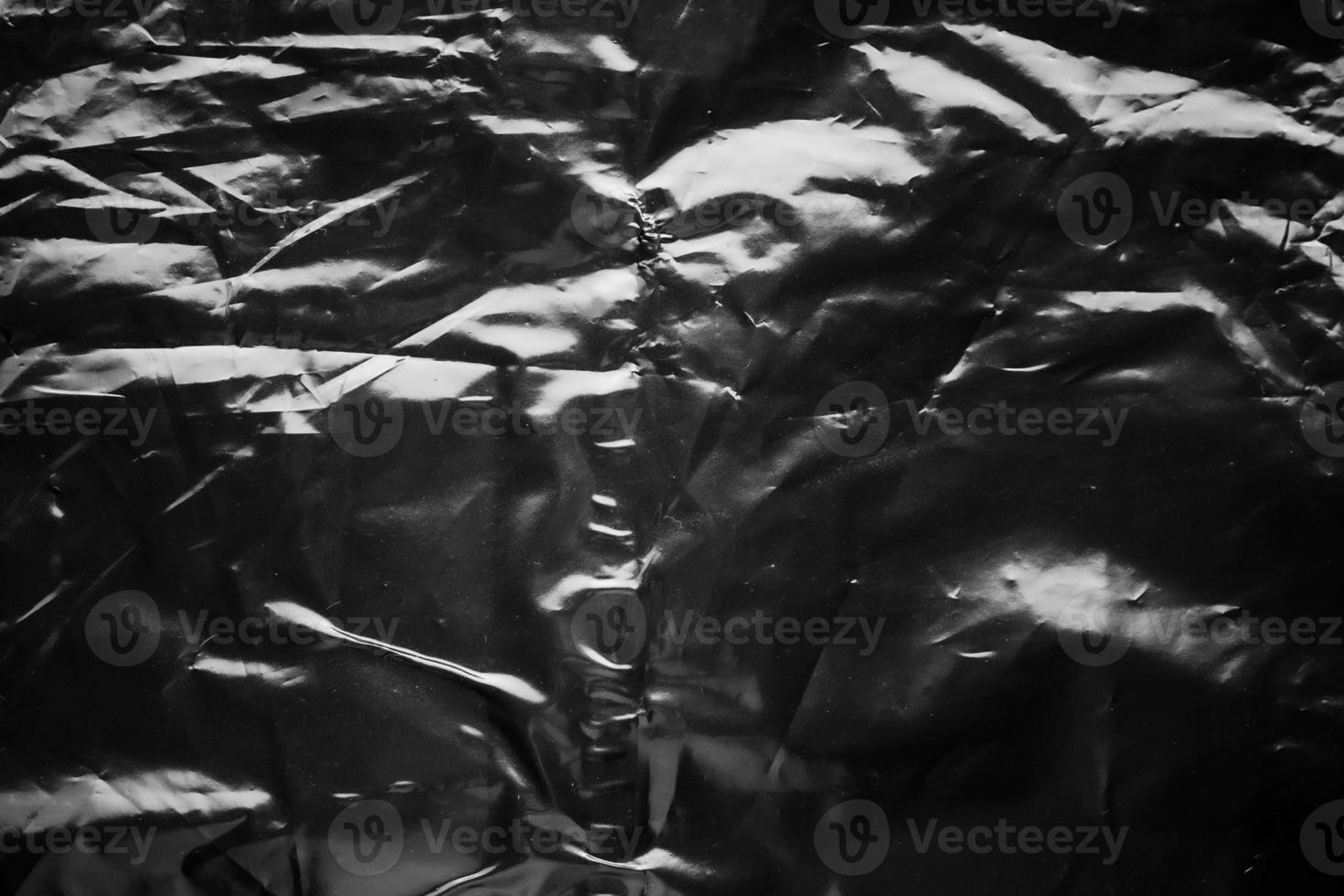 transparent plastic bag wrap overlay texture on black background photo