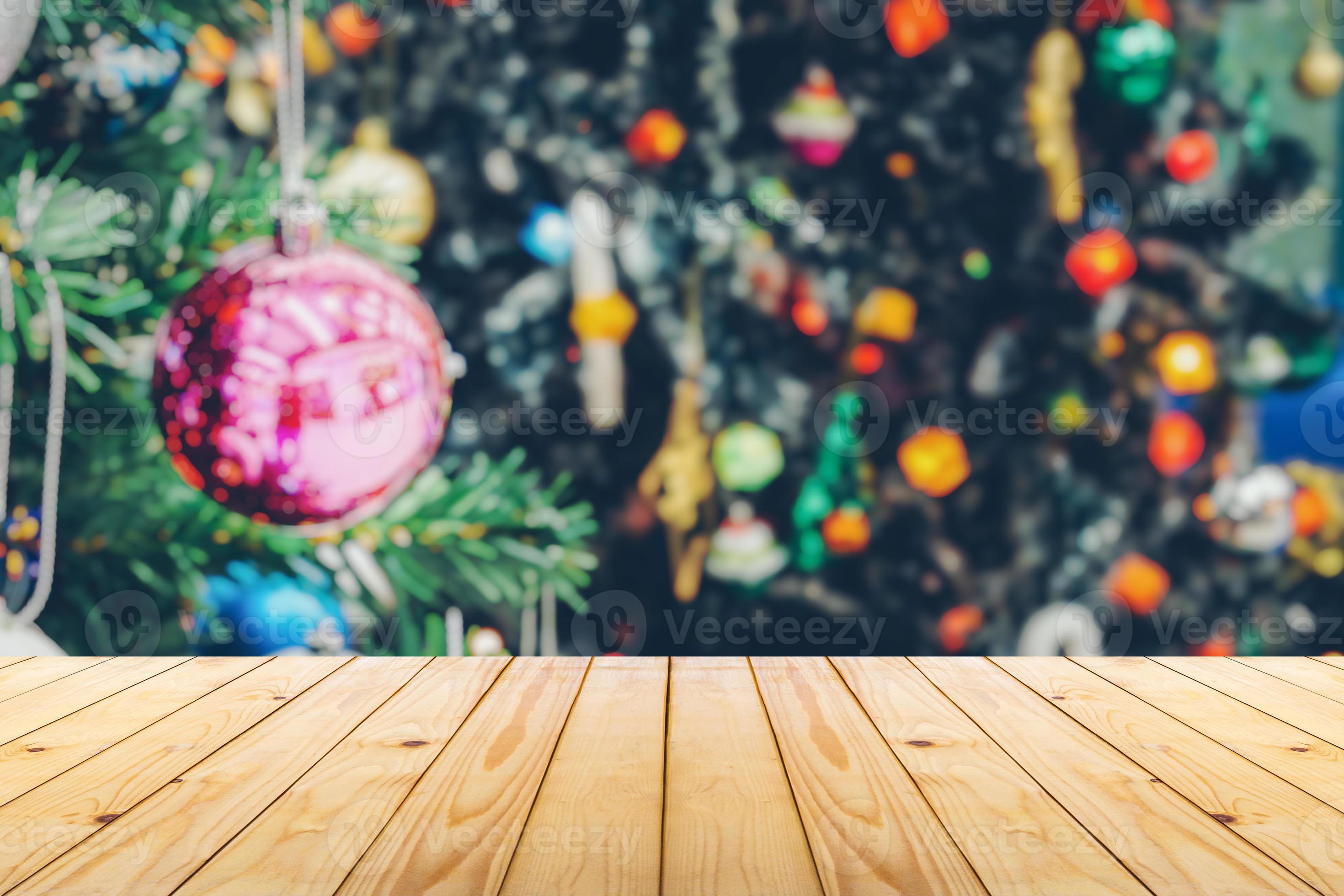 Empty wood table top with blur Christmas tree with bokeh light