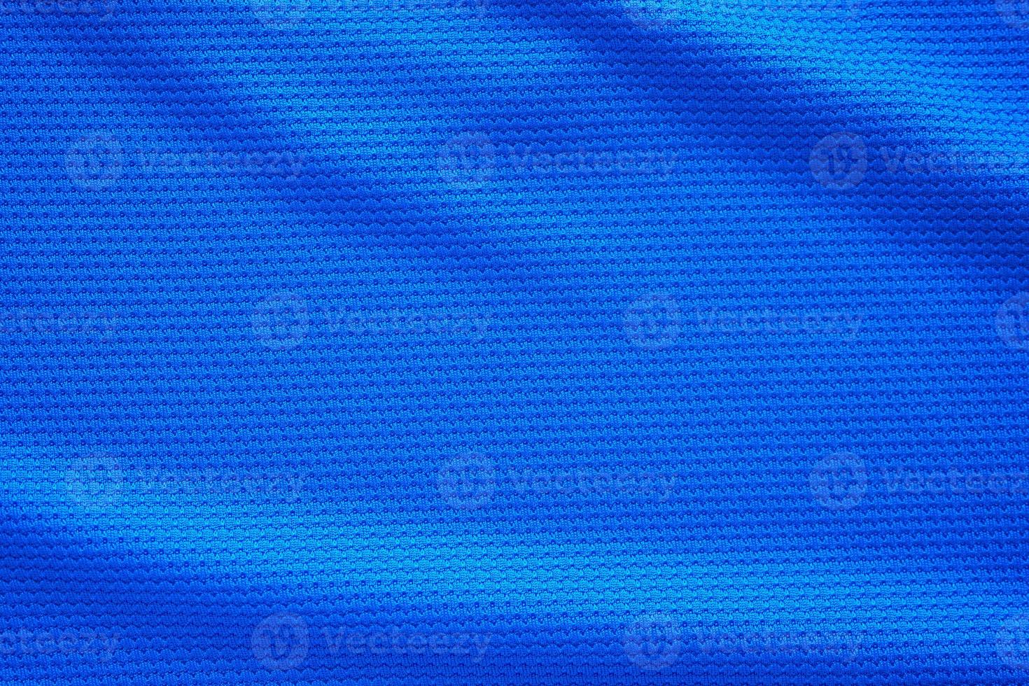 Blue football jersey clothing fabric texture sports wear background, close up top view photo