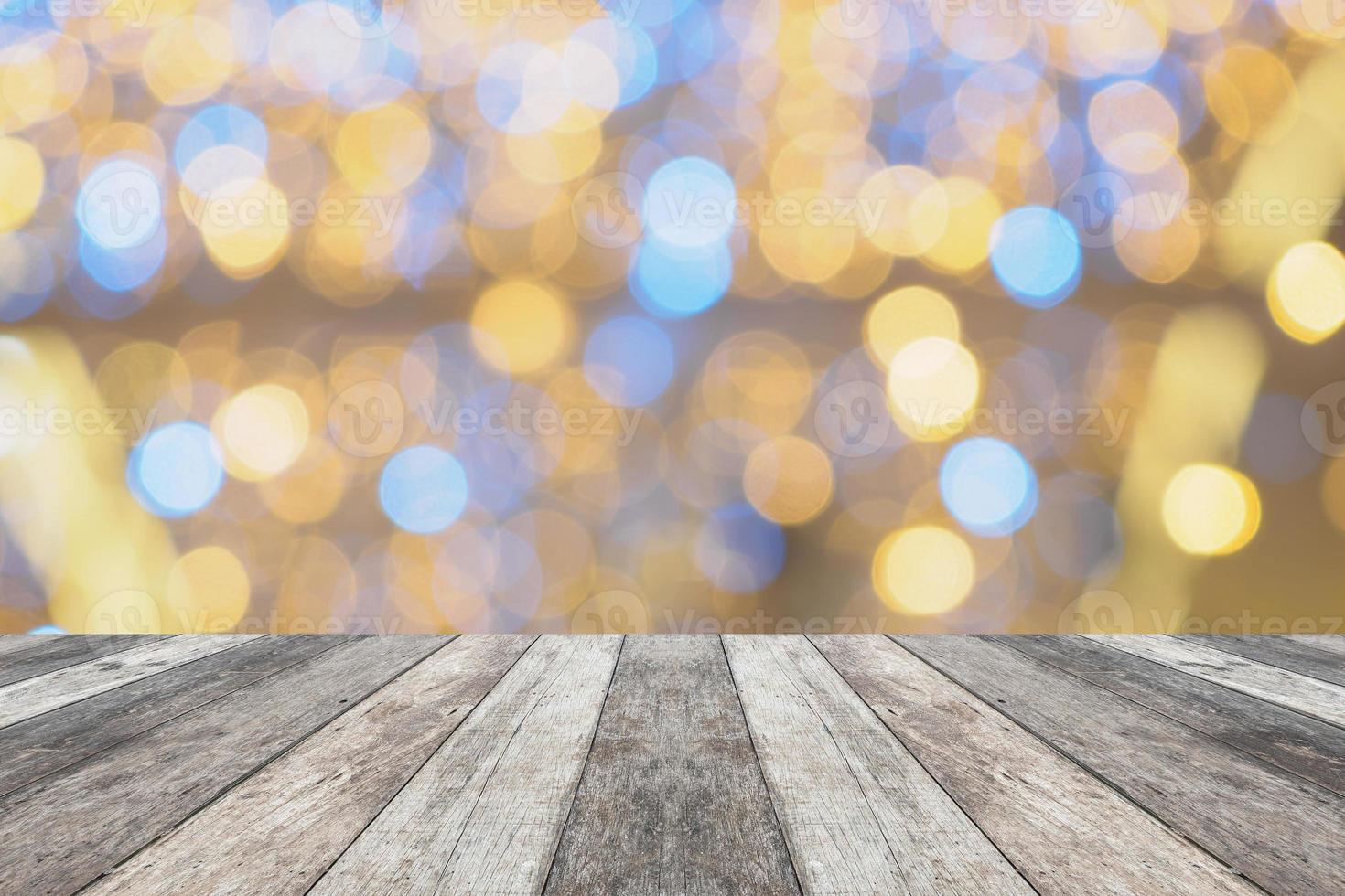 Empty wood table top with blur Christmas tree with bokeh light background photo
