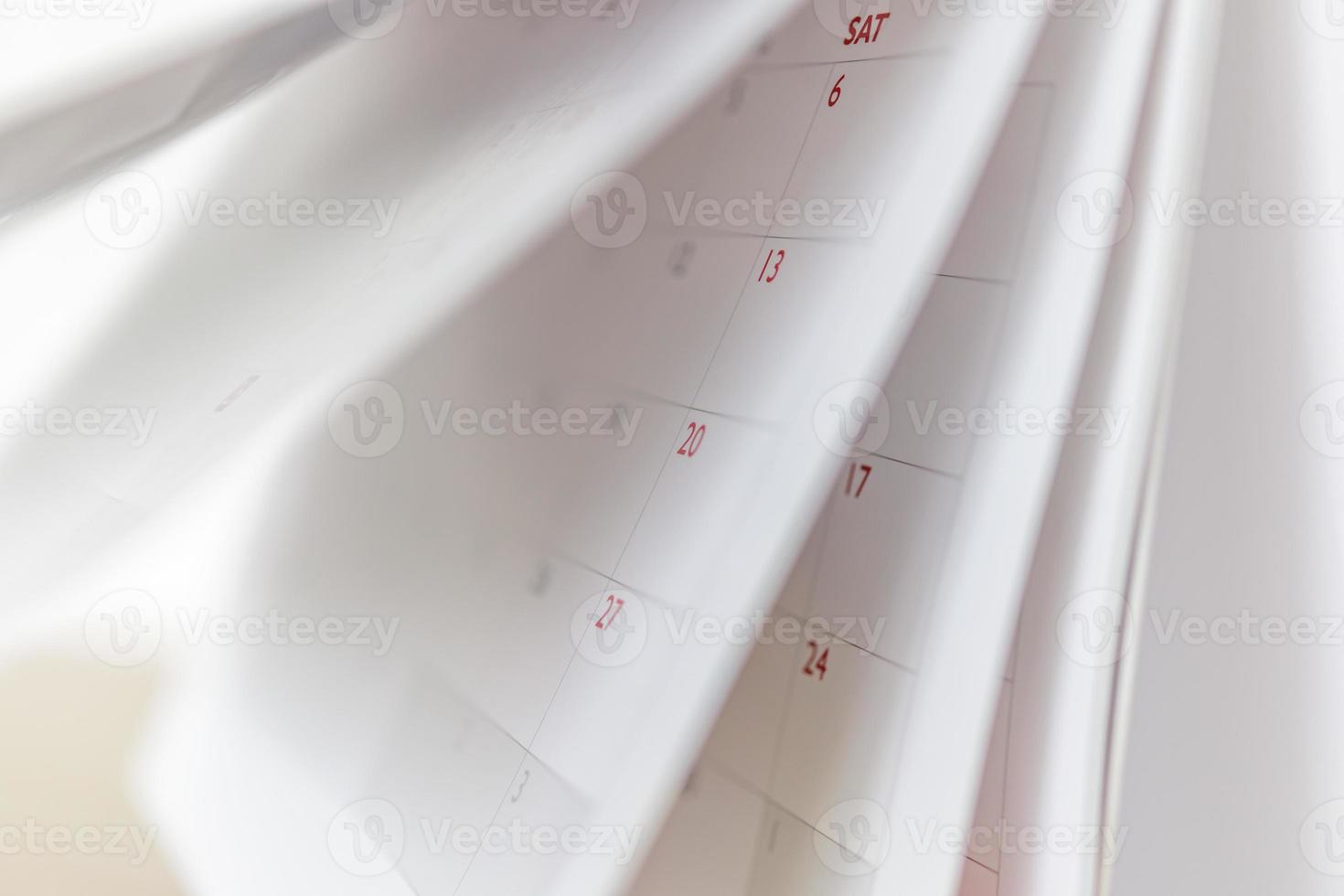 Calendar page flipping sheet close up blur background business schedule planning appointment meeting concept photo