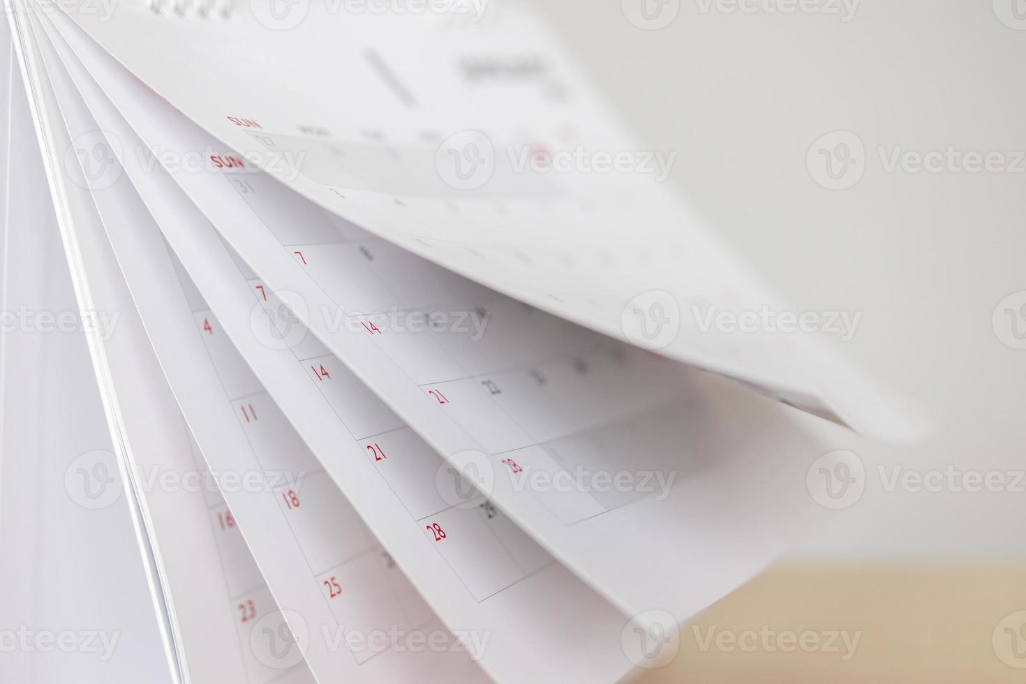 Calendar page flipping sheet on wood table background business schedule planning appointment meeting concept photo
