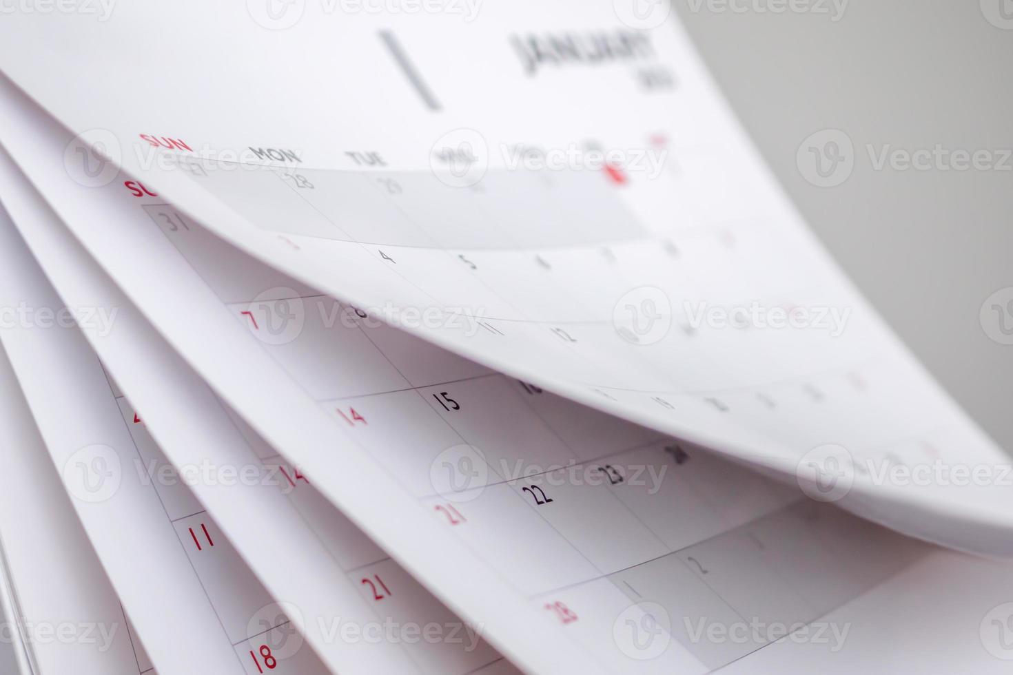 Calendar page flipping sheet close up blur background business schedule planning appointment meeting concept photo