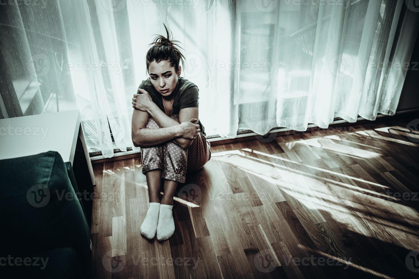 Woman Feeling Depression While Sitting Near The Window At Home photo
