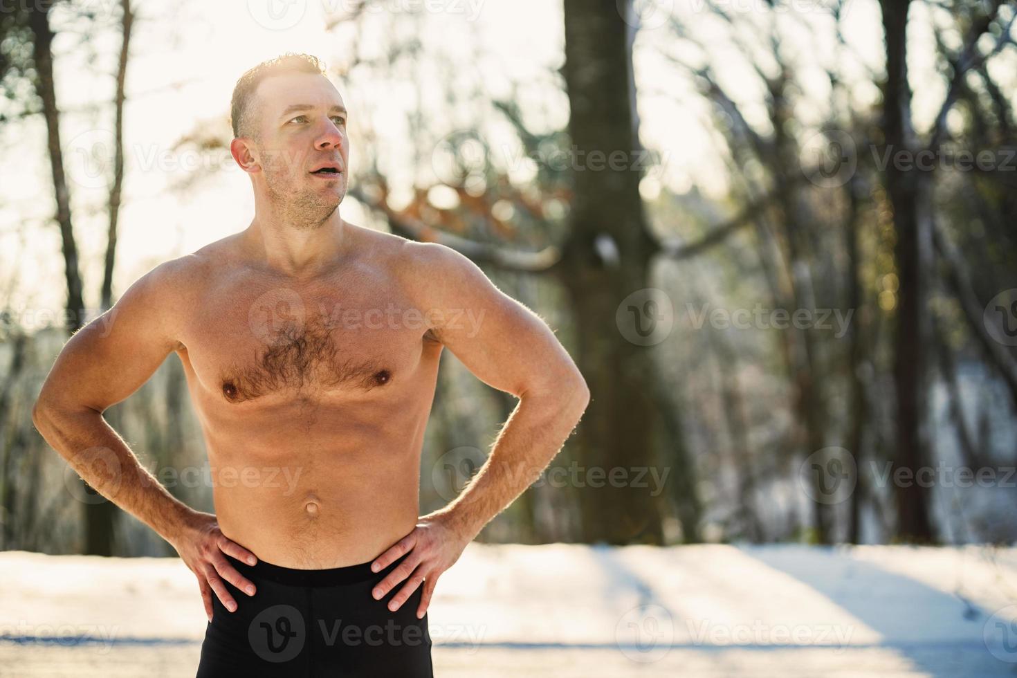 Man Doing Workout In The Forest In A Snowy Winter Day photo