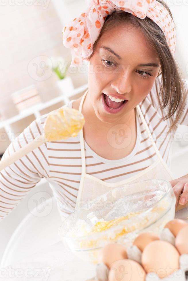 Happy young woman in the kitchen photo