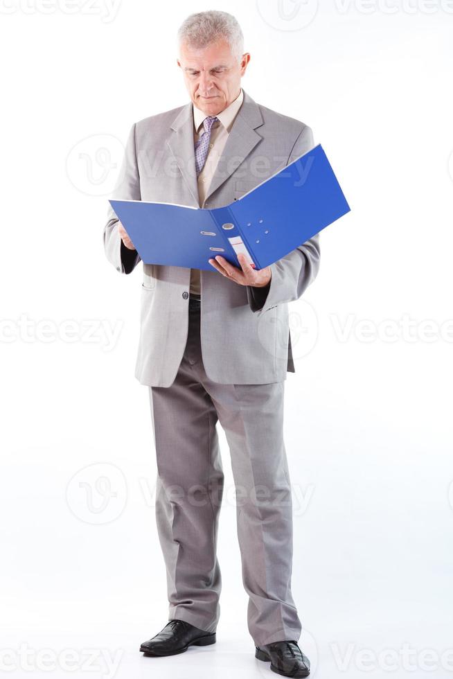 Senior Businessman Looking At Documents photo