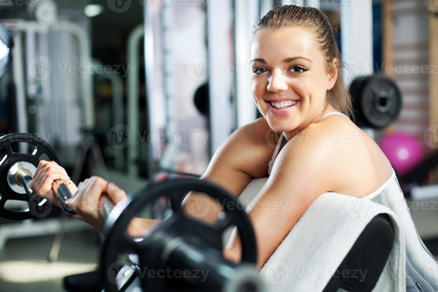 Young woman doing Biceps exercise photo