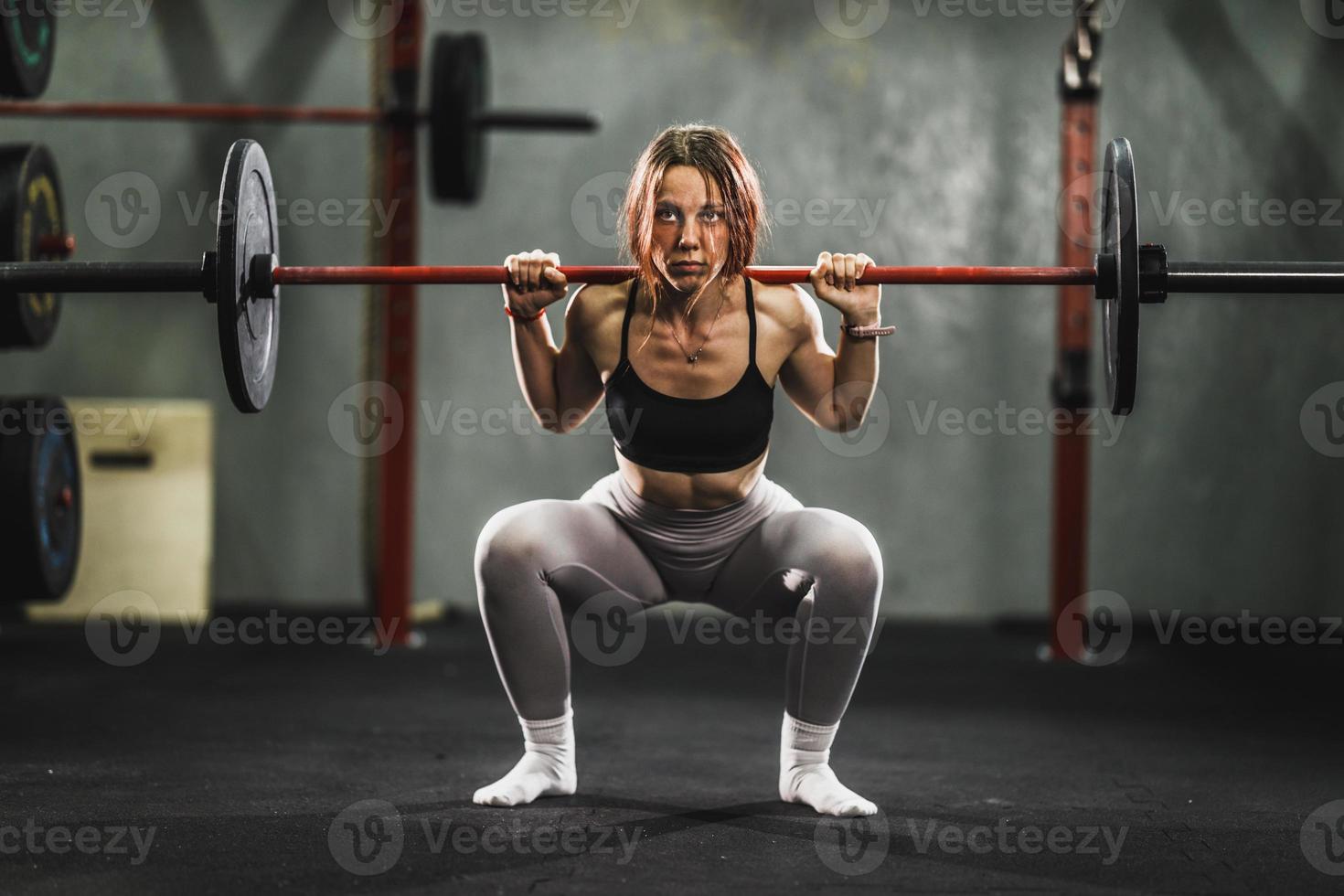 Woman Doing Squat Exercise At The Gym photo