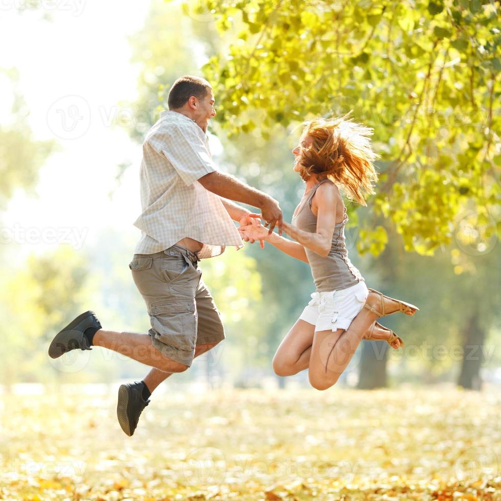 Happy Couple Jamping In The Park photo