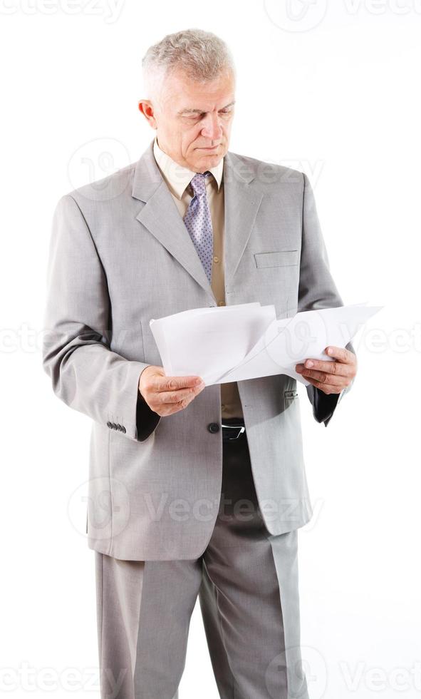 Senior Businessman looking at documents photo