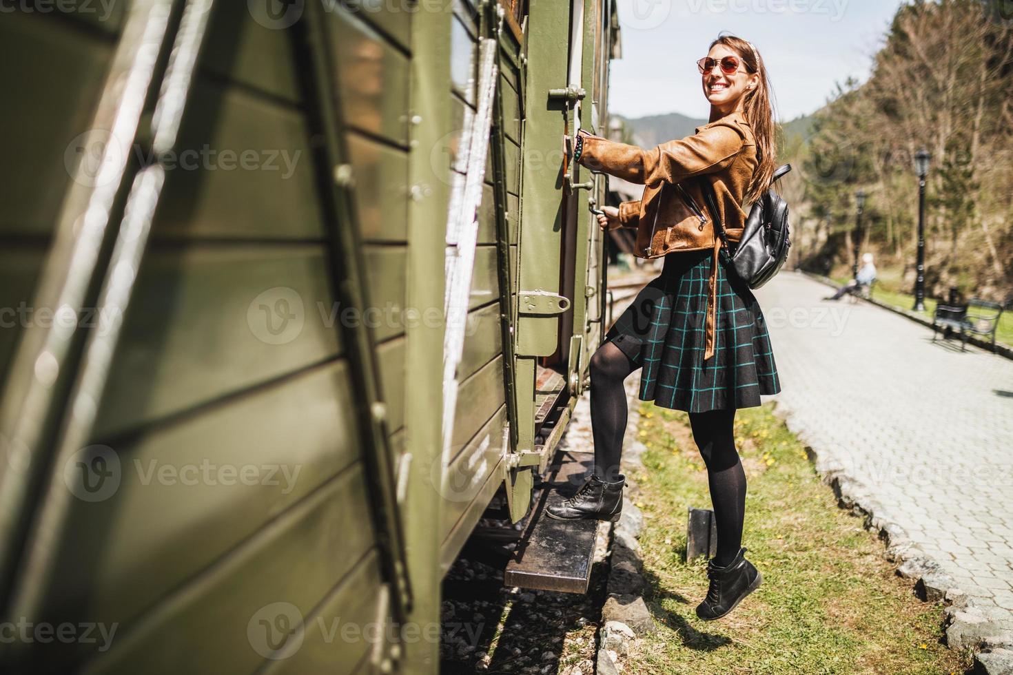 Woman Entering The Wagon Of Retro Train And Traveling To Adventure photo