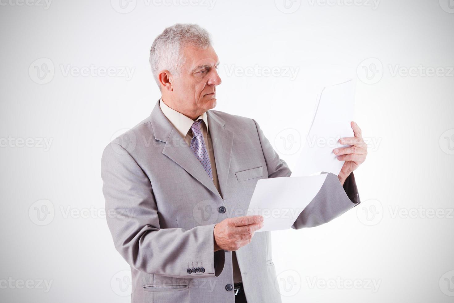 Senior Businessman Looking At Documents photo