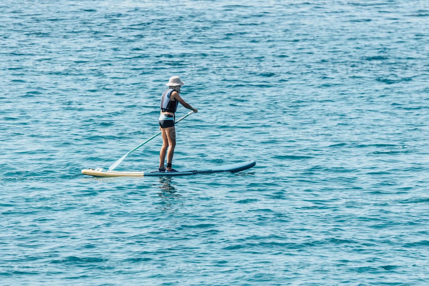 Boy Paddling On SUP or Stand Up Paddle Board In The Ocean Sea 14229797