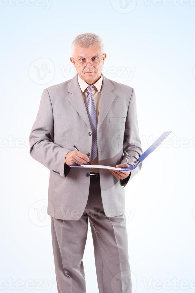 Successful Senior Businessman signing documents photo