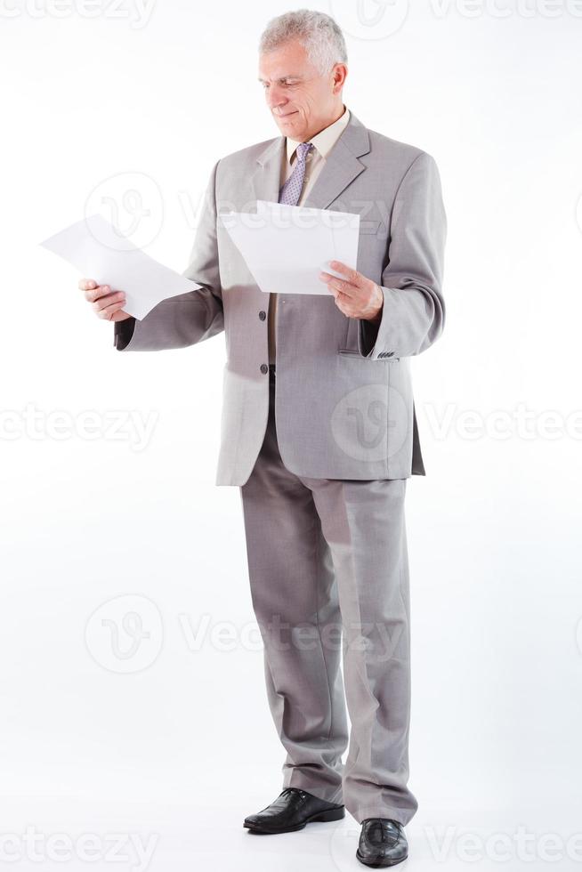 Senior Businessman Looking At Documents photo