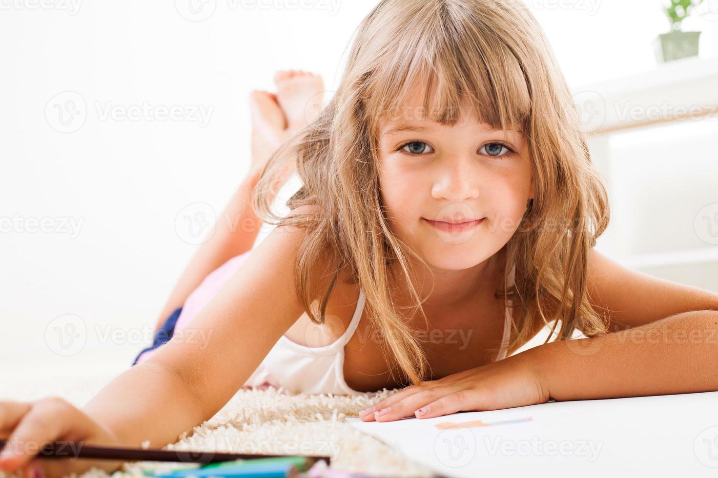 Little girl with color crayons photo