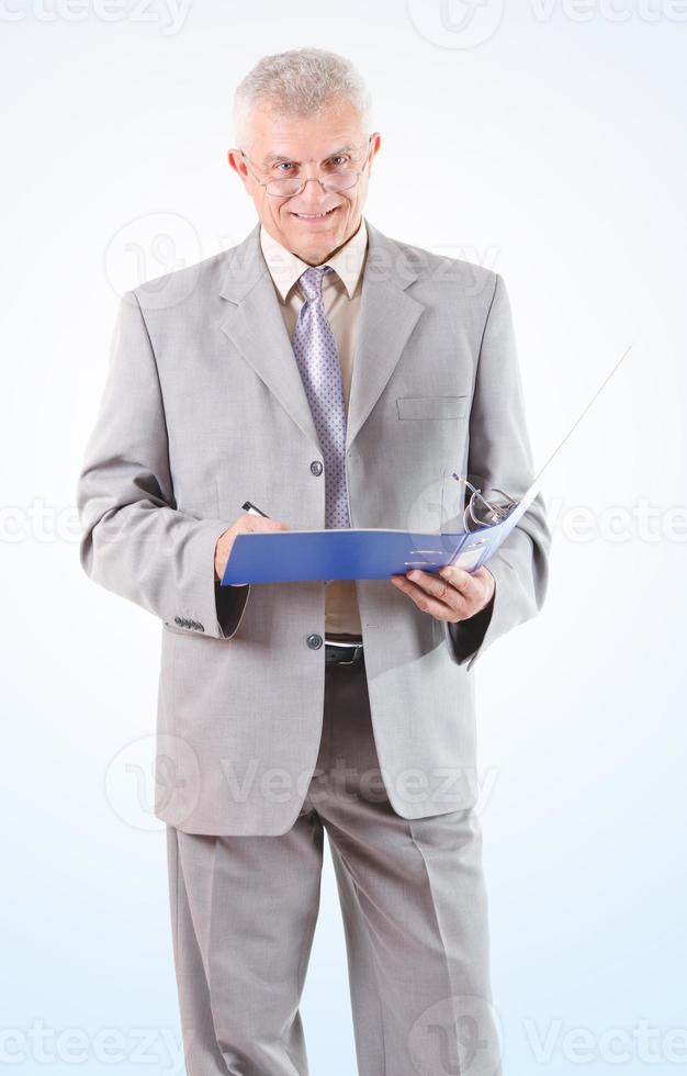 sonriente exitoso hombre de negocios senior firmando documentos foto