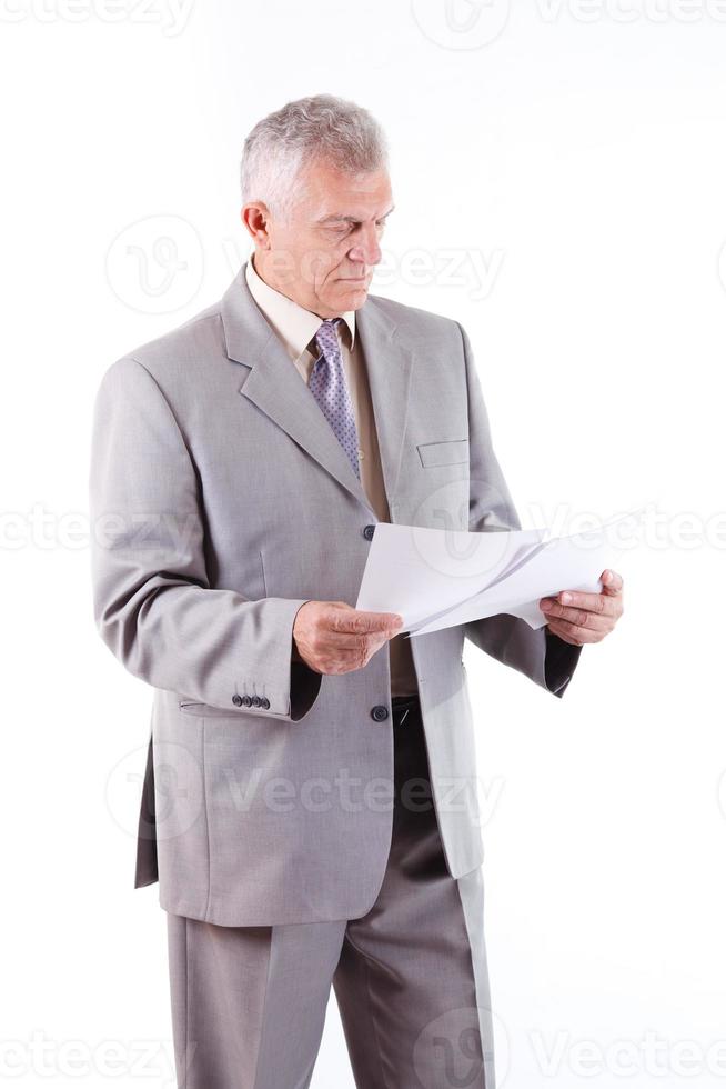 Senior Businessman looking at documents photo