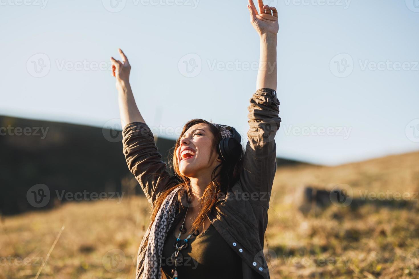 Woman Listening Music And Having Fun On The Meadow photo