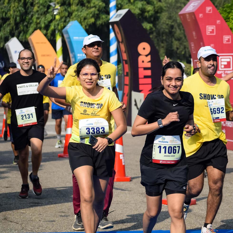New Delhi, India - October 16 2022 - Vedanta Delhi Half Marathon race after covid in which marathon participants about to cross the finish line, Delhi Half Marathon 2022 photo