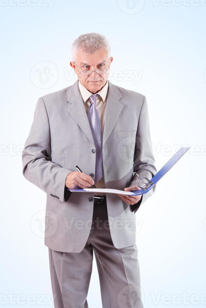 Successful Senior Businessman Signing Documents photo