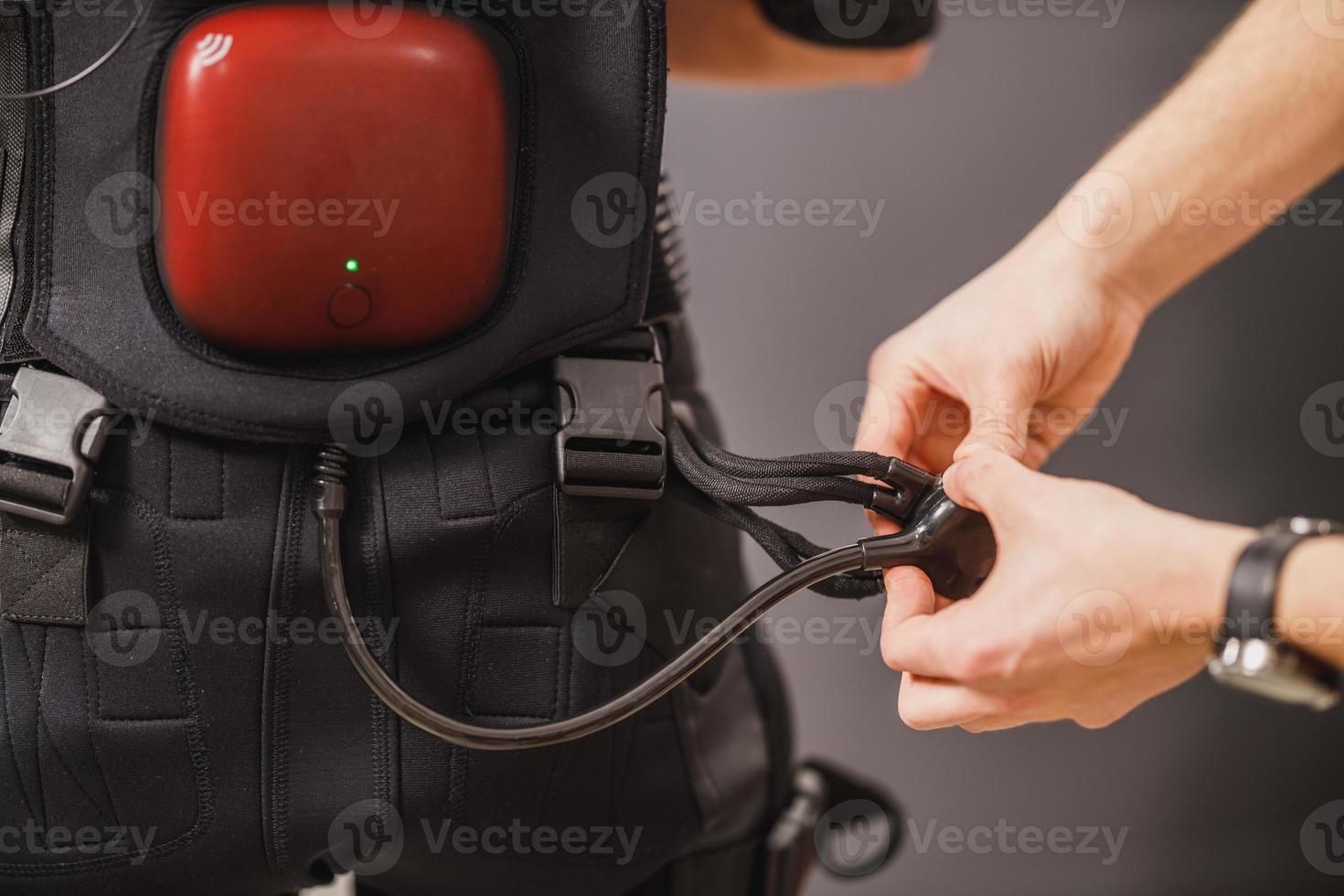 Fitness Instructor Putting An Ems Suit To A Woman photo