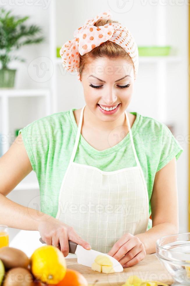 Young woman slicing apple photo