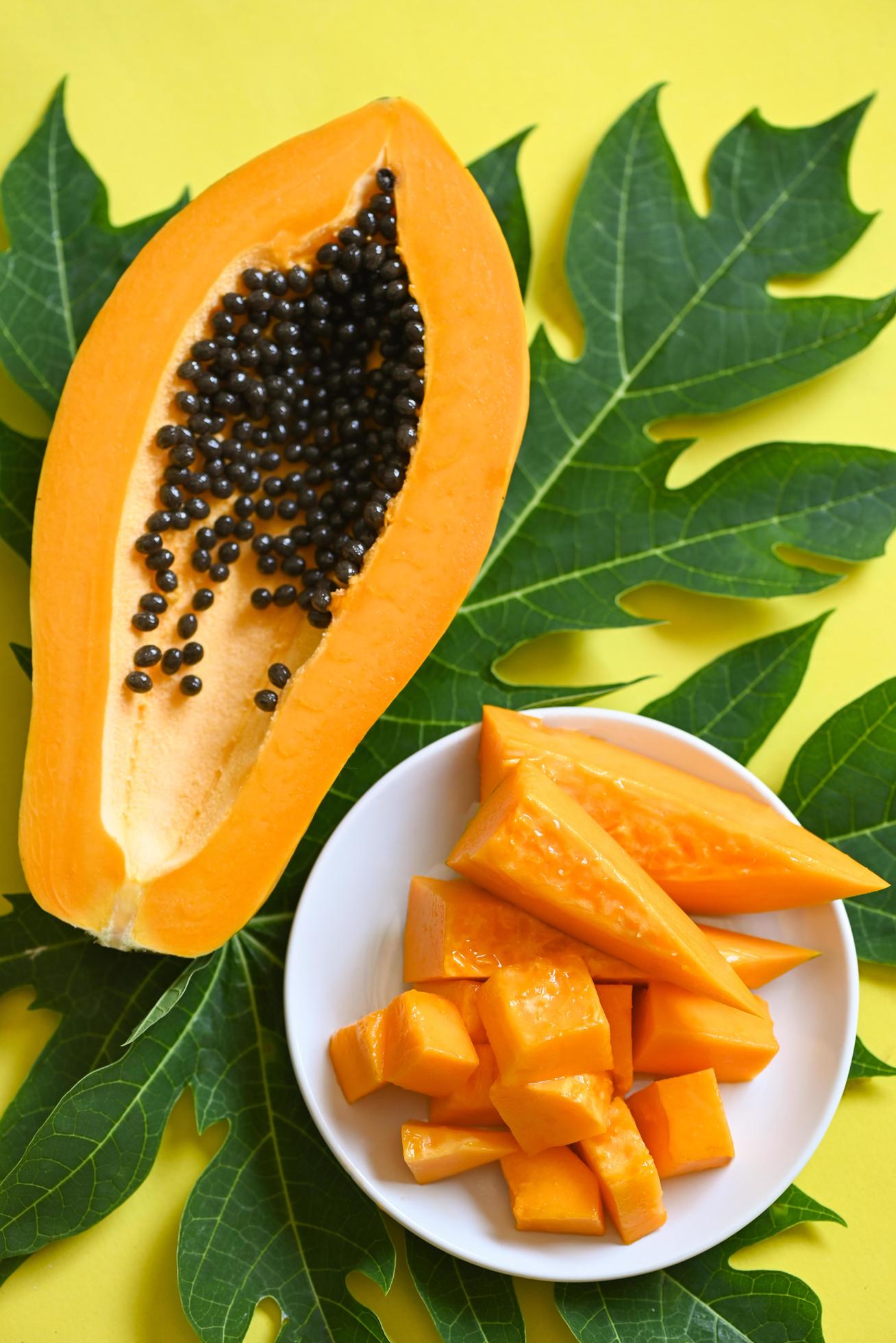 papaya fruits on yellow backgroud, fresh ripe papaya slice tropical