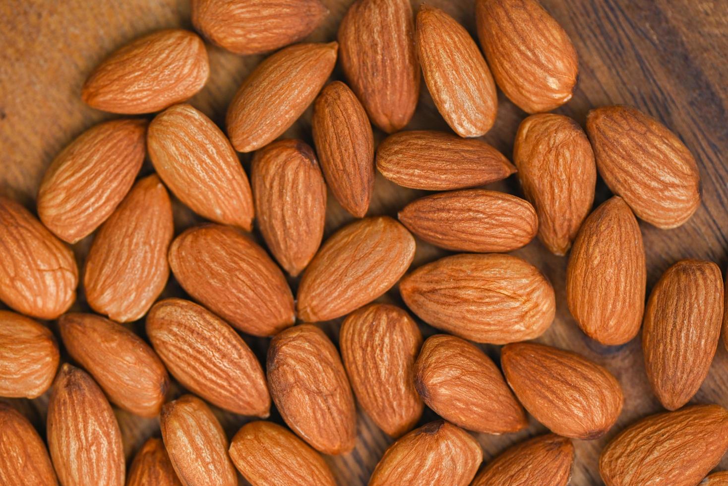 Almonds nuts on background, Close up delicious sweet almonds, roasted almond nut for healthy food and snack photo